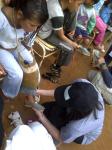Gowalla / AT&T Contest winner Mina fits TOMS Shoes on a child in San Pedro Province, Argentina